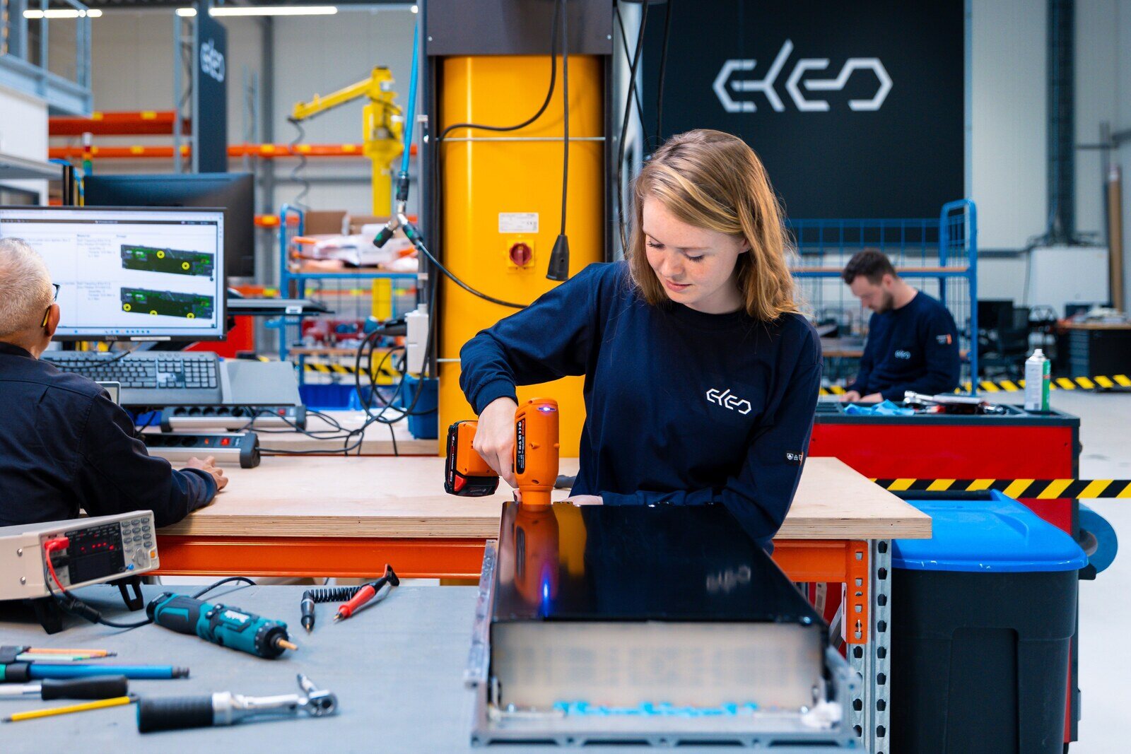 Female employee using drill